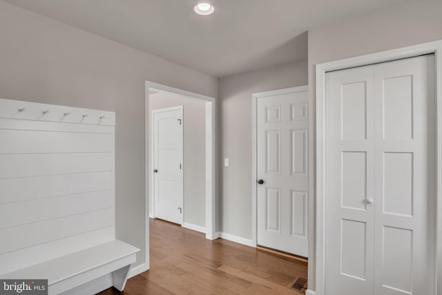 interior space with visible vents, baseboards, and wood finished floors