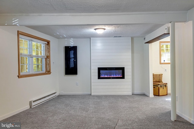 unfurnished living room with a baseboard heating unit, carpet flooring, a fireplace, and a textured ceiling