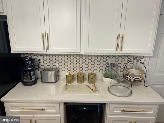 room details with white cabinets, beverage cooler, and backsplash