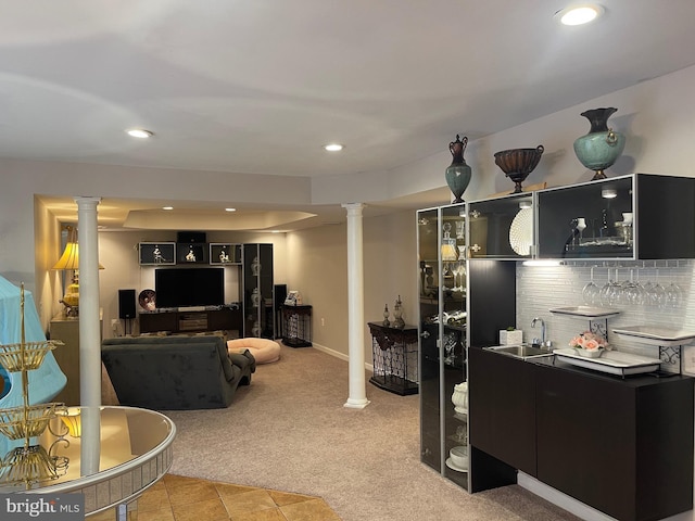 living area with baseboards, ornate columns, recessed lighting, indoor wet bar, and light colored carpet