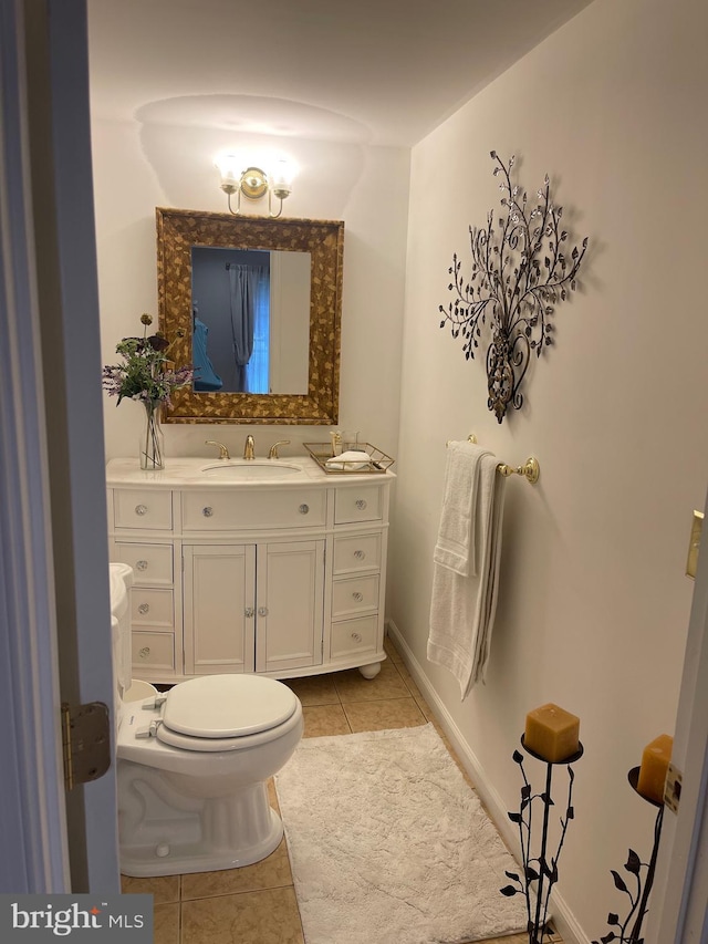 bathroom with tile patterned floors, toilet, and vanity