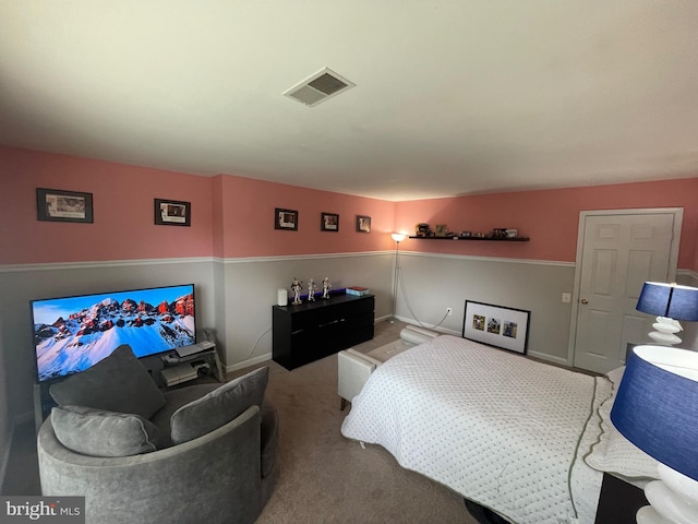 carpeted bedroom with visible vents and baseboards