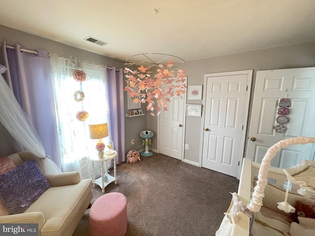 sitting room with visible vents, baseboards, and carpet