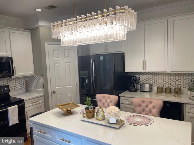 kitchen featuring tasteful backsplash, black appliances, crown molding, and white cabinetry