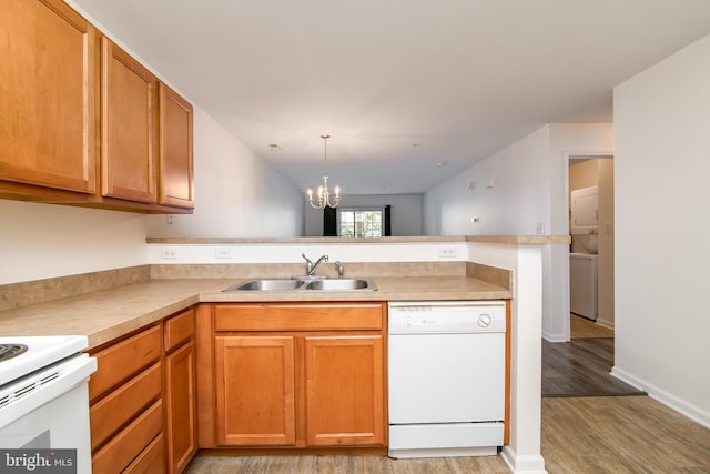 kitchen featuring dishwasher, kitchen peninsula, sink, and light hardwood / wood-style flooring