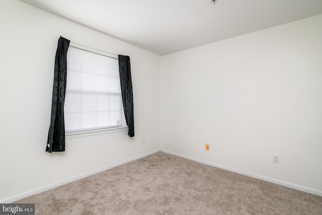 empty room featuring light colored carpet