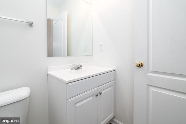 bathroom with toilet and vanity