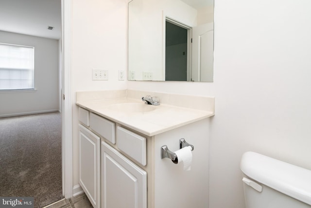 bathroom featuring vanity and toilet