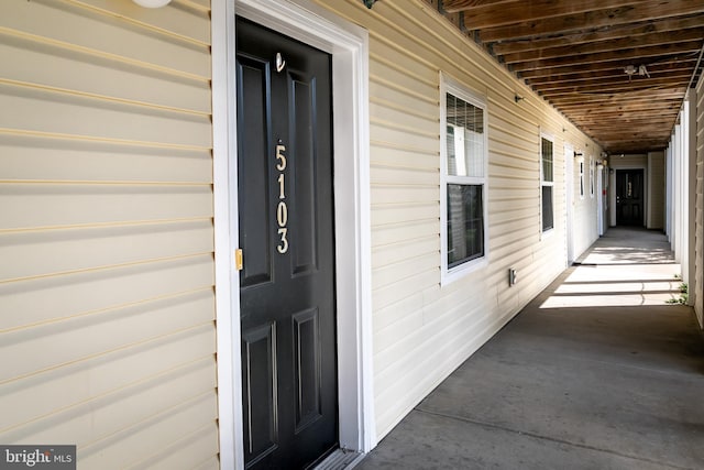 view of exterior entry featuring covered porch