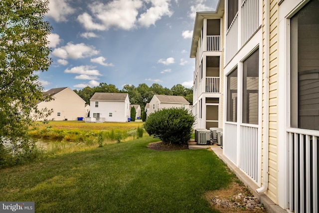 view of yard with a balcony and cooling unit