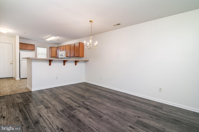 interior space featuring hardwood / wood-style floors and a notable chandelier