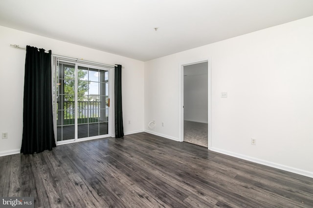 spare room featuring dark wood-type flooring