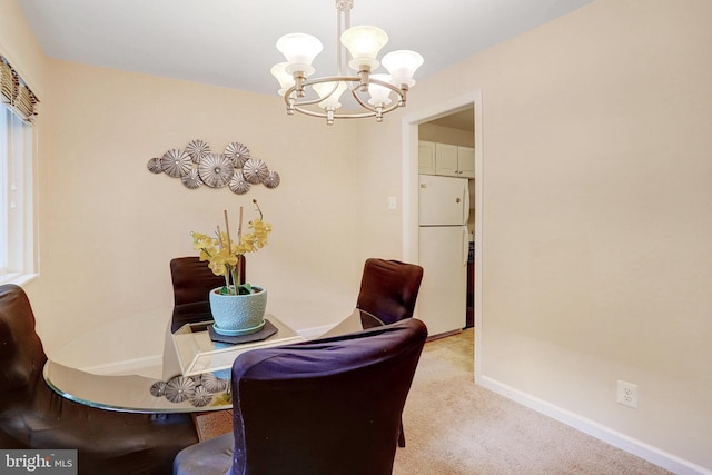 carpeted dining room with an inviting chandelier