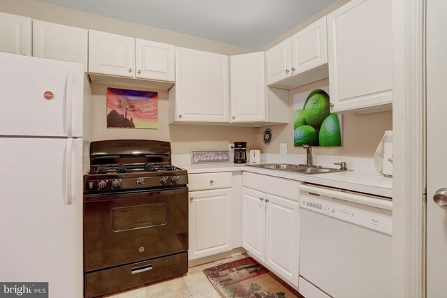 kitchen with white cabinets, light tile patterned floors, white appliances, and sink