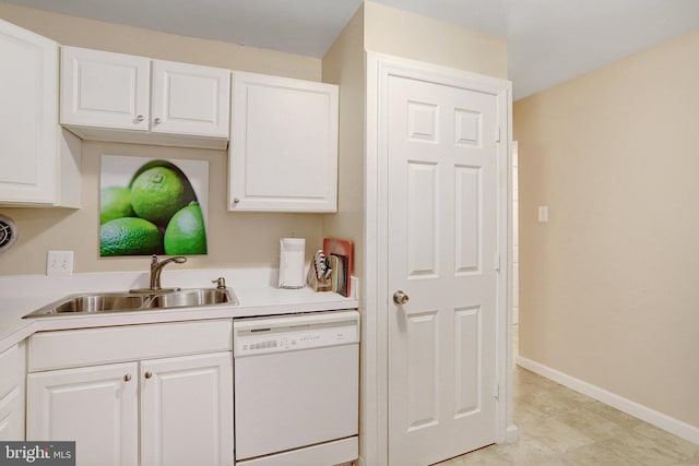 kitchen featuring dishwasher, light tile patterned floors, white cabinetry, and sink