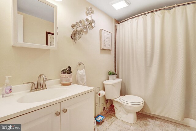 bathroom featuring toilet, a shower with curtain, vanity, and tile patterned floors