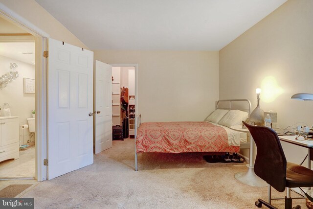 carpeted bedroom featuring ensuite bathroom