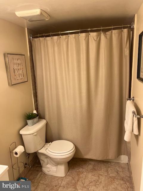 bathroom featuring tile patterned flooring and toilet