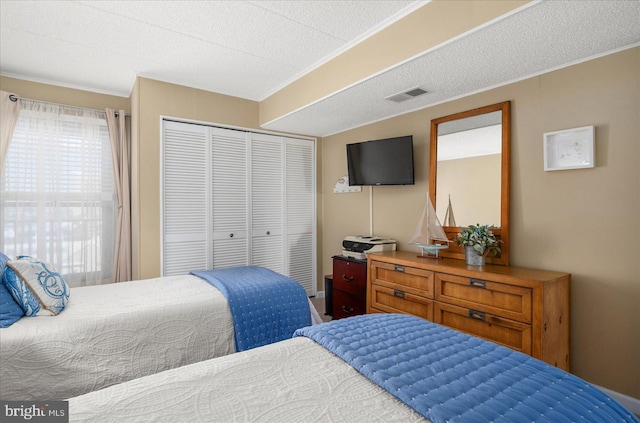 bedroom with a closet and a textured ceiling