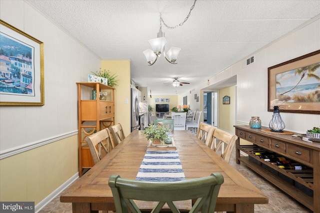 dining area with a textured ceiling and ceiling fan