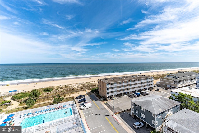 birds eye view of property with a view of the beach and a water view