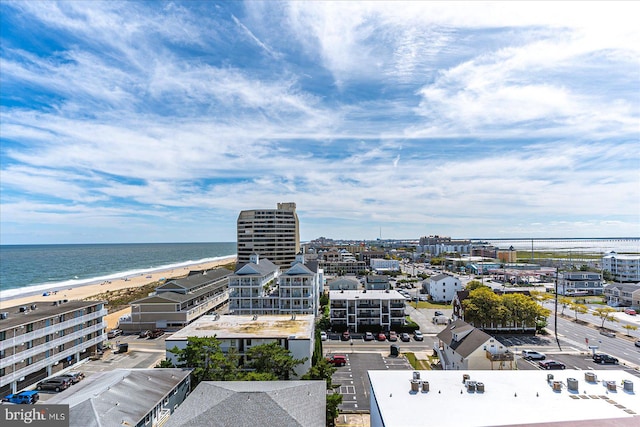 aerial view with a water view and a beach view