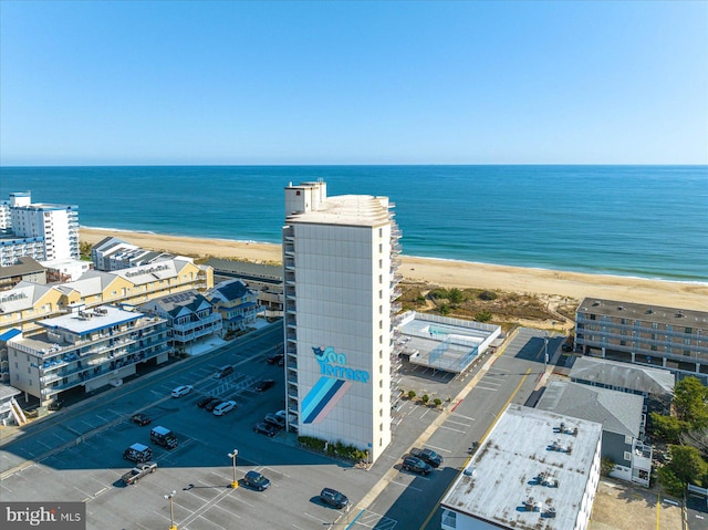 drone / aerial view featuring a water view and a beach view