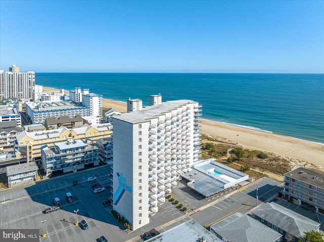 birds eye view of property with a beach view and a water view