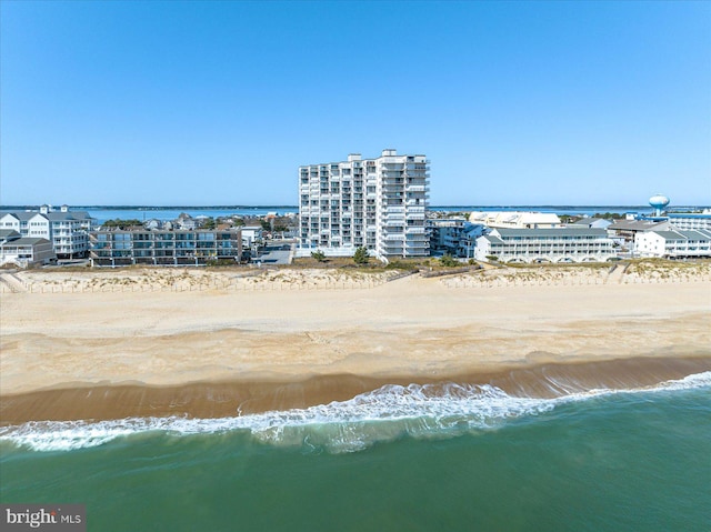 bird's eye view featuring a view of the beach and a water view