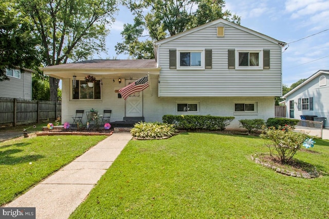 split level home featuring a front lawn