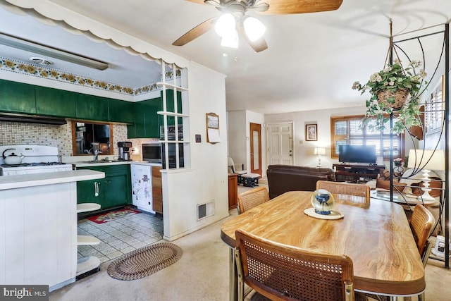 dining area featuring ceiling fan and sink