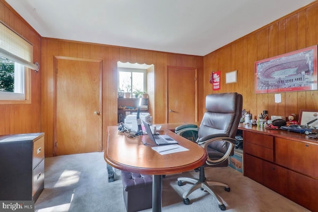 carpeted office featuring wooden walls