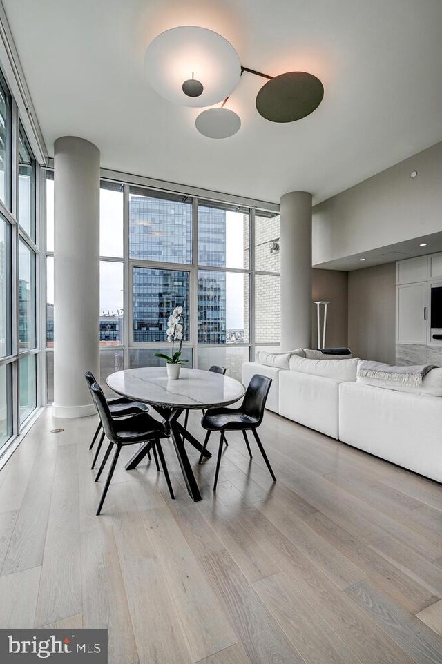 dining room featuring light hardwood / wood-style flooring and floor to ceiling windows