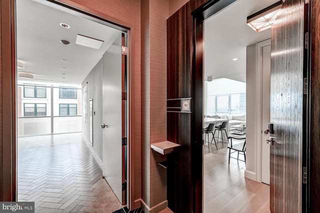 corridor with light hardwood / wood-style flooring