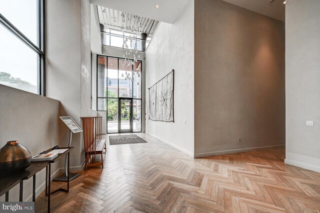 entryway featuring a high ceiling and light parquet flooring