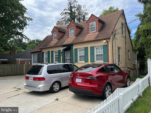 view of front of property with brick siding and fence private yard