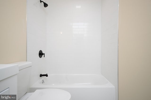 bathroom featuring shower / bathing tub combination and toilet