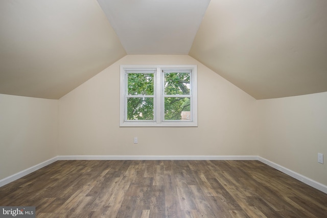 bonus room featuring lofted ceiling, wood finished floors, and baseboards