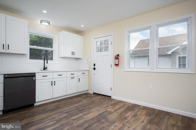 kitchen featuring sink, dark wood-type flooring, decorative backsplash, black dishwasher, and white cabinets