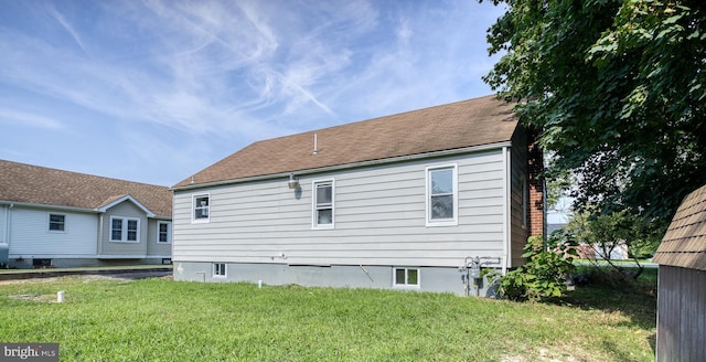 rear view of house featuring a yard