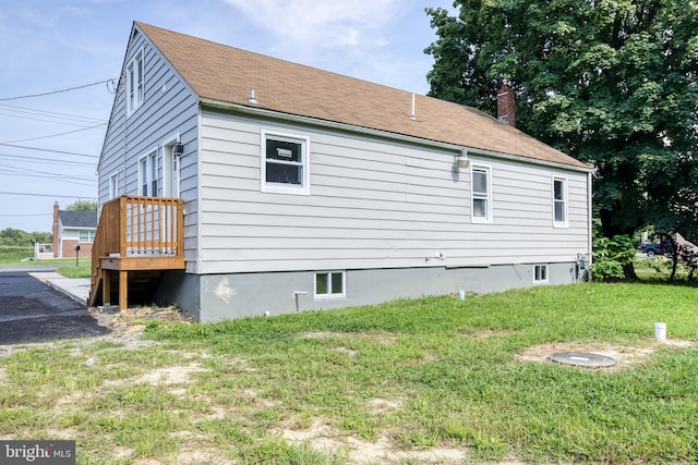 exterior space with a lawn and a chimney