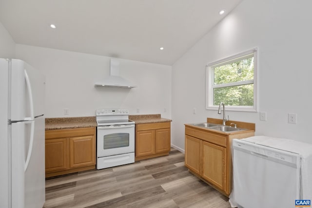 kitchen with vaulted ceiling, white appliances, wall chimney exhaust hood, light hardwood / wood-style floors, and sink