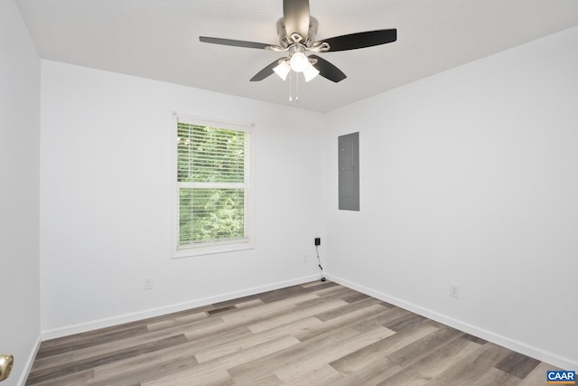 unfurnished room featuring light wood-type flooring, ceiling fan, and electric panel