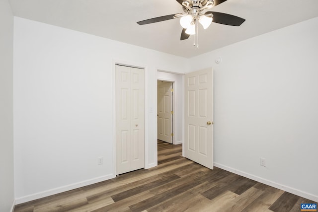 unfurnished bedroom with ceiling fan and dark hardwood / wood-style flooring