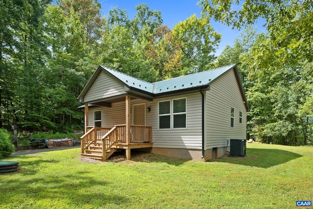 rear view of house featuring central AC, a lawn, and a deck