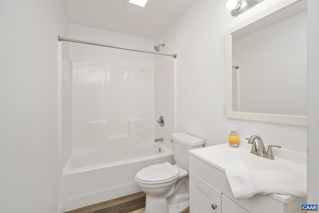 full bathroom with vanity, toilet, hardwood / wood-style flooring, and washtub / shower combination