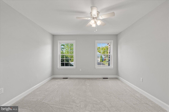 empty room with visible vents, carpet floors, and baseboards