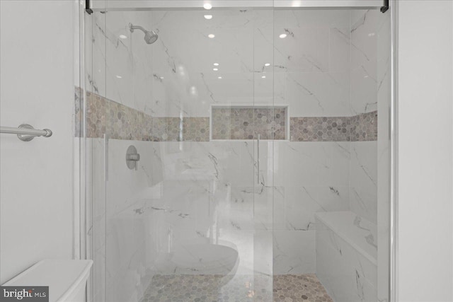 bathroom with a marble finish shower