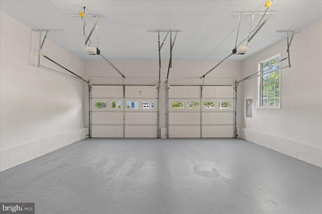 garage featuring electric panel and a garage door opener