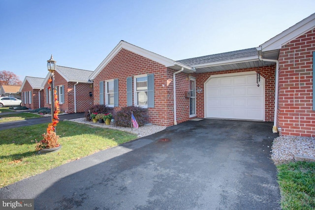 ranch-style house with a front yard and a garage